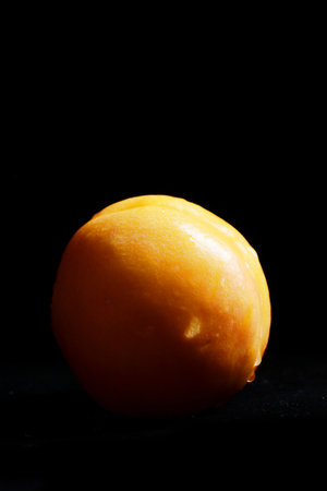 Yellow peach on a tableの写真素材