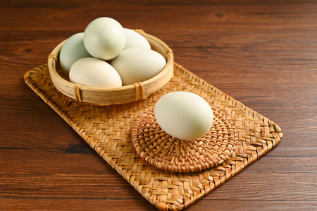 Close up colorful red yolk of salted duck eggs preserved in bamboo basket, asian style foodの写真素材