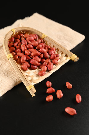Peanuts in a basket on a black background, close-upの写真素材