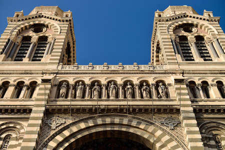 Detail of the front facade with an arch two towers and saints sculptures of the Cathedrale La Major in Marseillesの写真素材