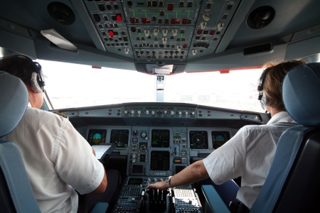 Jet airplane cockpit with two pilots crewmembers