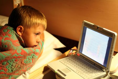 kid fascinated by a laptop computer