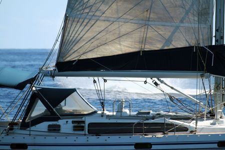 modern sailboat with a whale splash in the background
