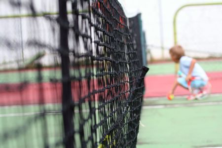 tennis net wit boy in backgroundの写真素材