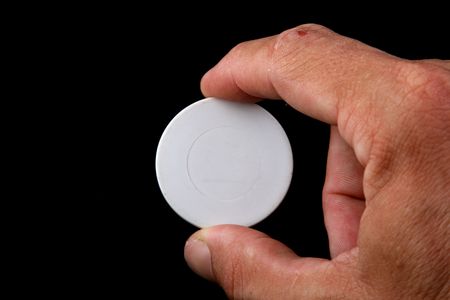 white poker coin with handの写真素材