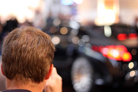 man taking a photo of a sports carの写真素材