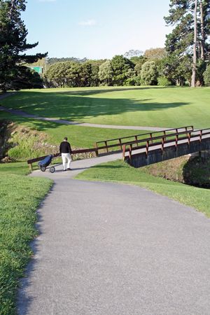 golfer walking on a bridgeの写真素材