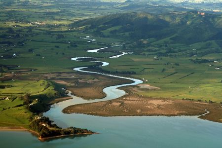 Sinuous river going into the sea