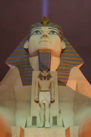 statue of a sphinx head at night