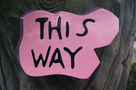 sign with this way direction arrowの写真素材