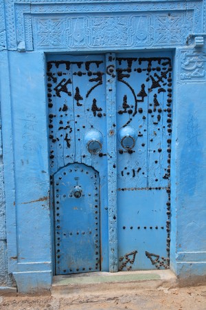 ancient blue door in tunisian art styleの写真素材
