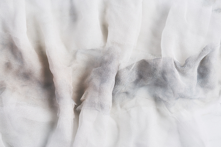 White and gray wrinkled silk. Air folds. Silk fabric texture for background or design element. Thin tissue.の写真素材