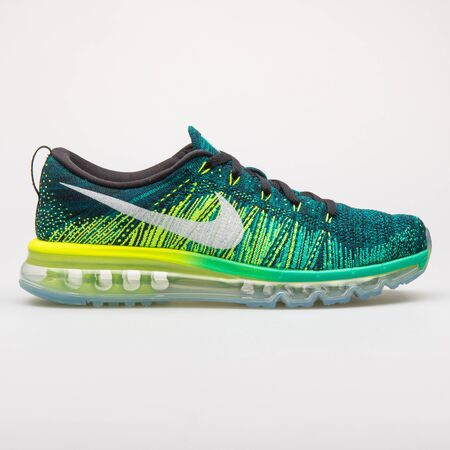 VIENNA, AUSTRIA - AUGUST 28, 2017: Nike Flyknit Max green and yellow sneaker on white background.のeditorial素材