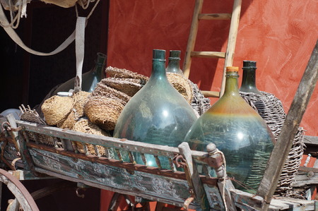 Carboys, demijohn bottles on an old cartの写真素材