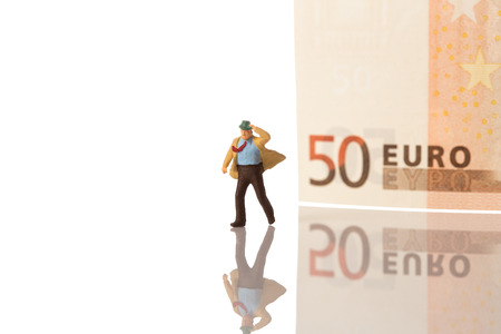businessman figurine running with euro banknote background,isolated on white with clipping pathの写真素材