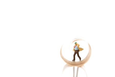 miniature businessman figurine running on a euro banknote on whiteの写真素材