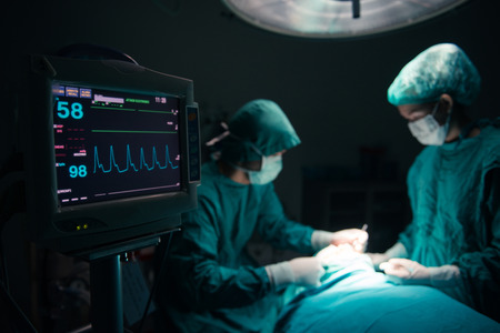 Surgeons team working with Monitoring of patient in surgical operating room. selective focus on Monitorの写真素材