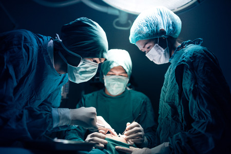 Serious surgeons during a surgery in the hospitalの写真素材