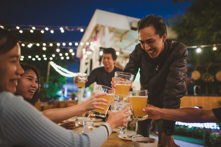 Group Of Friends celebrating the festival and Enjoying Evening Drinks,vintage style.の写真素材