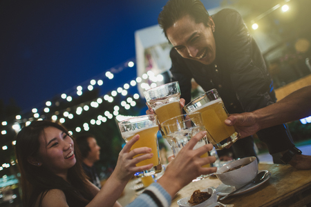 Cheers to the best friends,Group Of Friends Enjoying Evening Drinks,vintage style.の写真素材