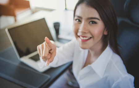 Young business woman touching the screen with her finger,deep and shallow focusの写真素材