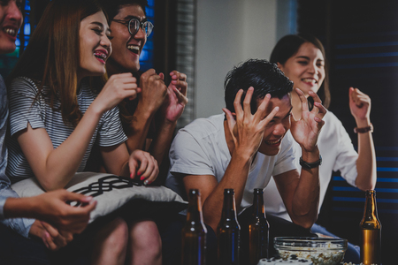 Young fans watching sports on TV with beer and snacks,friendship, drink, alcohol, holidays and people concept