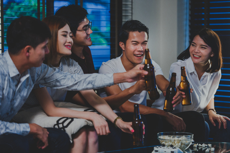 Group of Friends making a popcorn with beer,Celebration of winning favourites football teamの写真素材