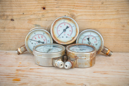 Pressure gauges on wood background