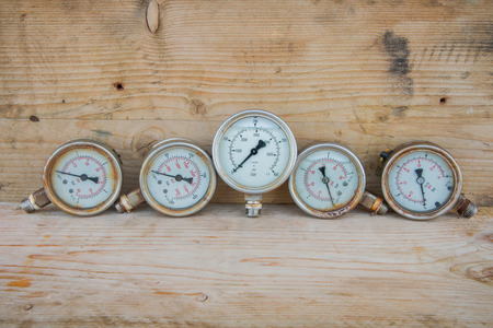 Pressure gauges on wood background