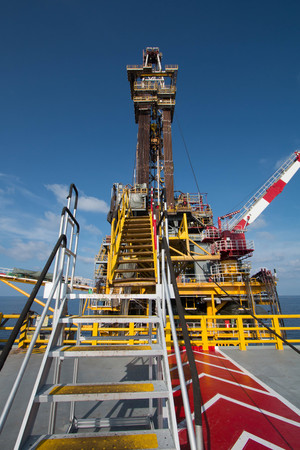 Offshore oil and rig platform in sunset or sunrise time. Construction of production process in the...