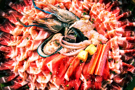 raw slice pork , egg and sea food  for shabuの写真素材