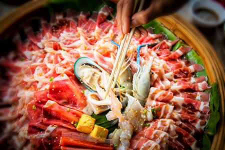 raw slice pork , egg and sea food  for shabuの写真素材