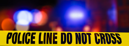 Police line tape with text police line do not cross on dark backgroundの写真素材