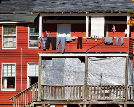Laundry drying on the balcony of a wooden houseの写真素材