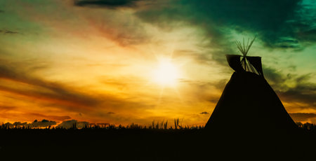 Silhouette of indian teepee on sunset sky background. landscape photography