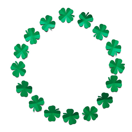 Emerald green paper clover shamrock leafs wreath border frame on white background isolated.の写真素材
