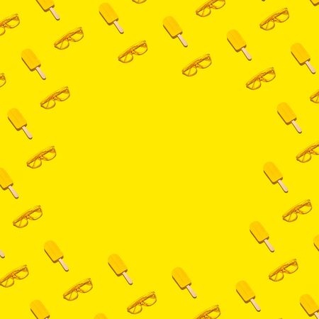 Sunglasses and ice pops border frame on yellow abstract background