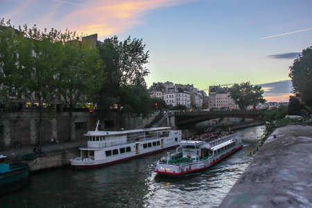 Boat tour cruising on Seine river at sunset in Parisのeditorial素材