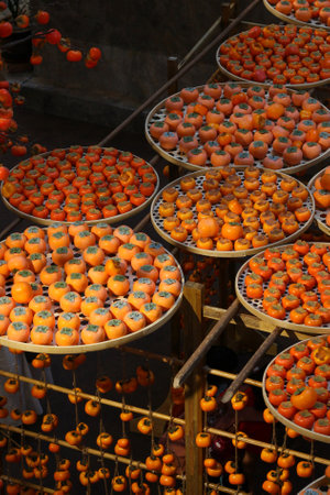 The persimmons decorated on the rattan round trayの写真素材