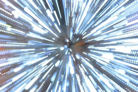 Photograph of burst zoom motion of white light in the night