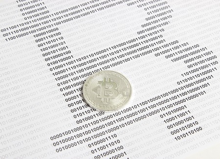 silver bitcoin on the background of binary codeの写真素材