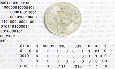 silver bitcoin on the background of binary codeの写真素材