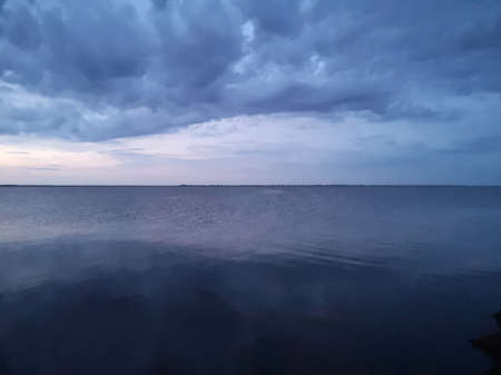 sunset in the river reflects the sky with cloudsの写真素材