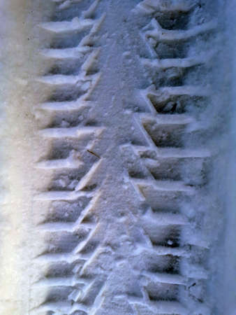 Car tire tread on snow print winterの写真素材