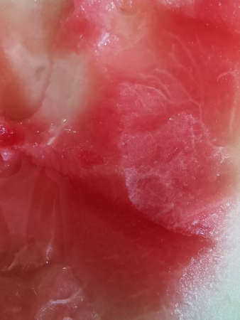 red ripe watermelon with black seeds on the table