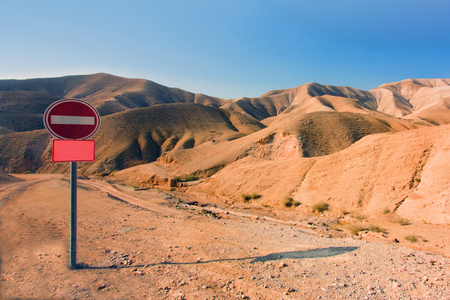 Stop-signal at the middle of nowhere - in the Israel desert. Landscape of the sunny day, sand hills under clear blue sky. Outdoorsの写真素材