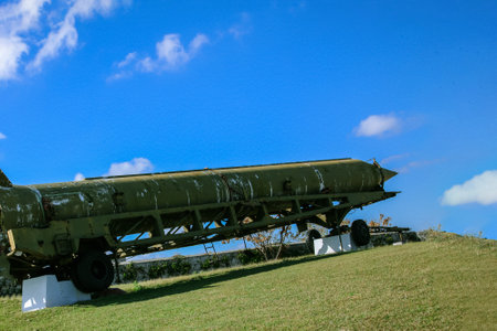The old and broken, scratched Soviet Union rocket settled on Cuba, pointed out to the blue sky, outdoors.のeditorial素材