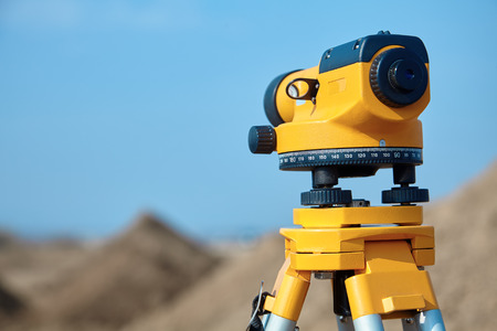 Special device (level) for surveyor builders, geodesy equipment close up. Outdoors, copy space.の写真素材