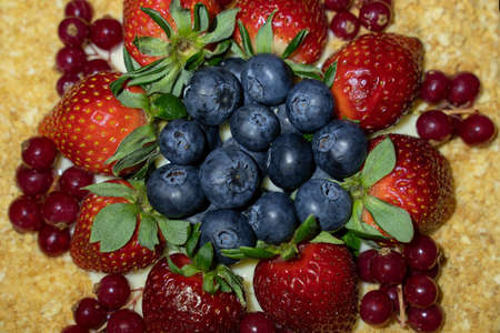 Top of cake decorated with mixed berries. Napoleon, blueberries, strawberries and redcurrant. Soft...