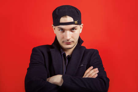 Portrait of young handsome caucasian man crossing the hands with confident ironic look right to the...